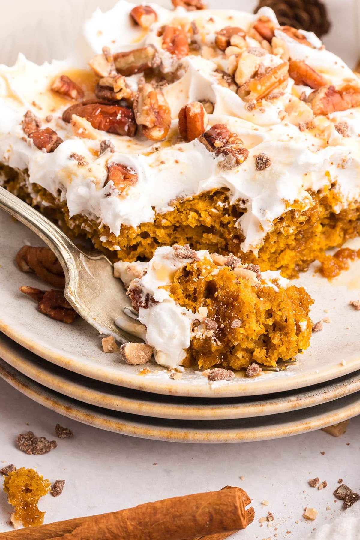 Pumpkin Spice Poke Cake serving with a fork