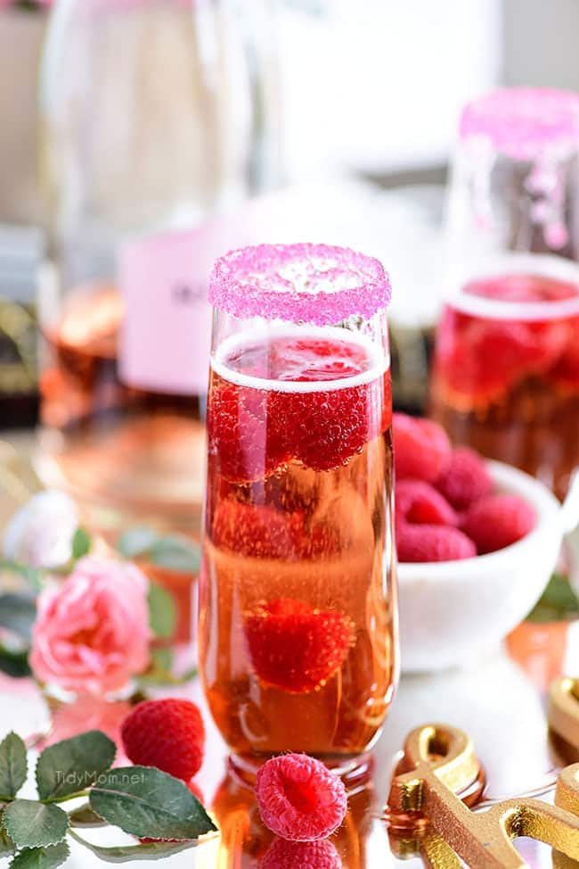 Raspberry Kir Royale cocktail in champagne flute and sugar rim