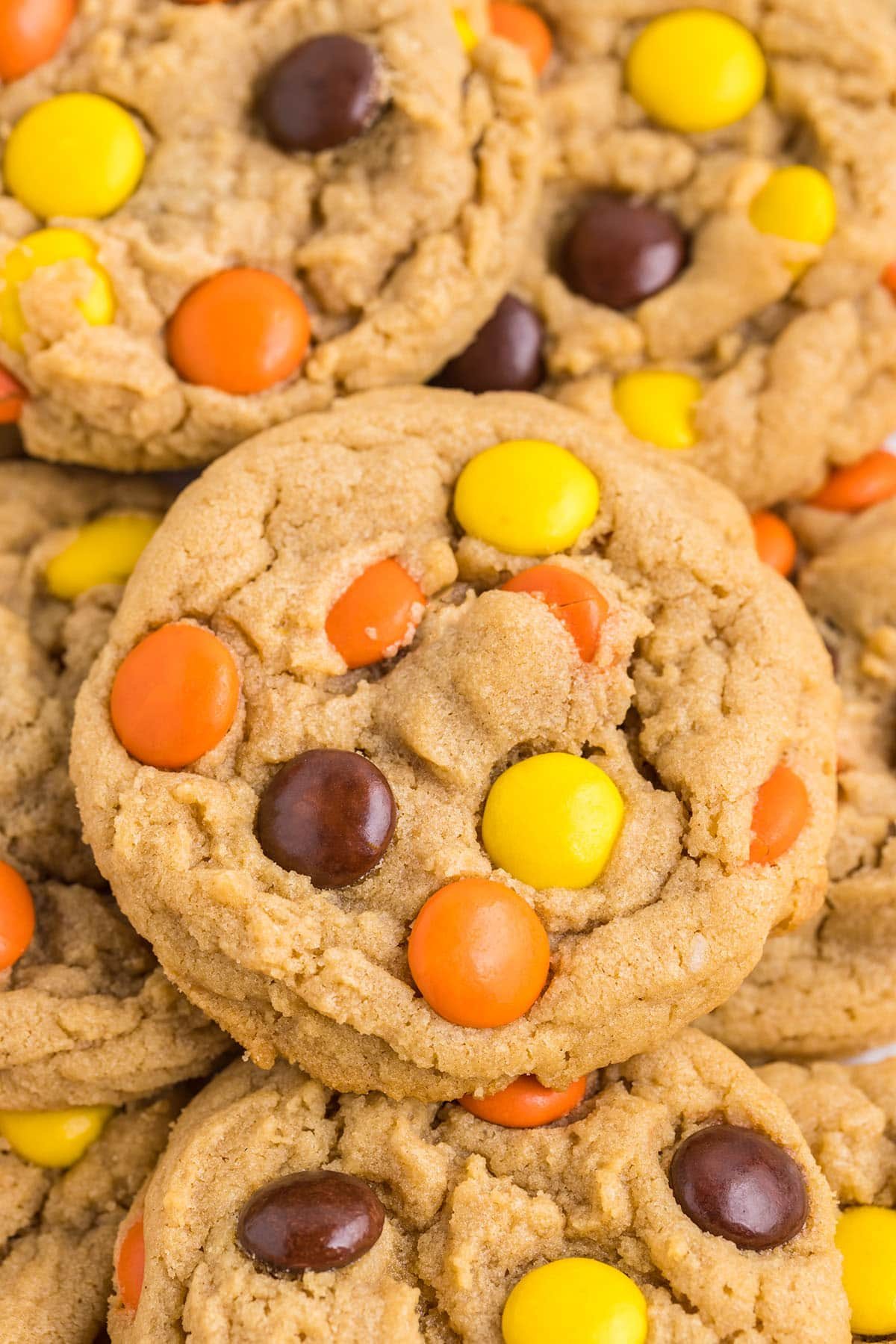 a pile of peanut butter cookies with Reese's Pieces