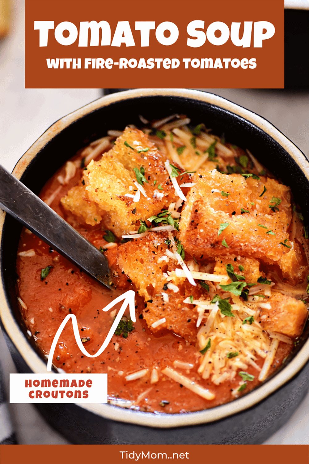 delicious tomato soup in a black bowl with croutons