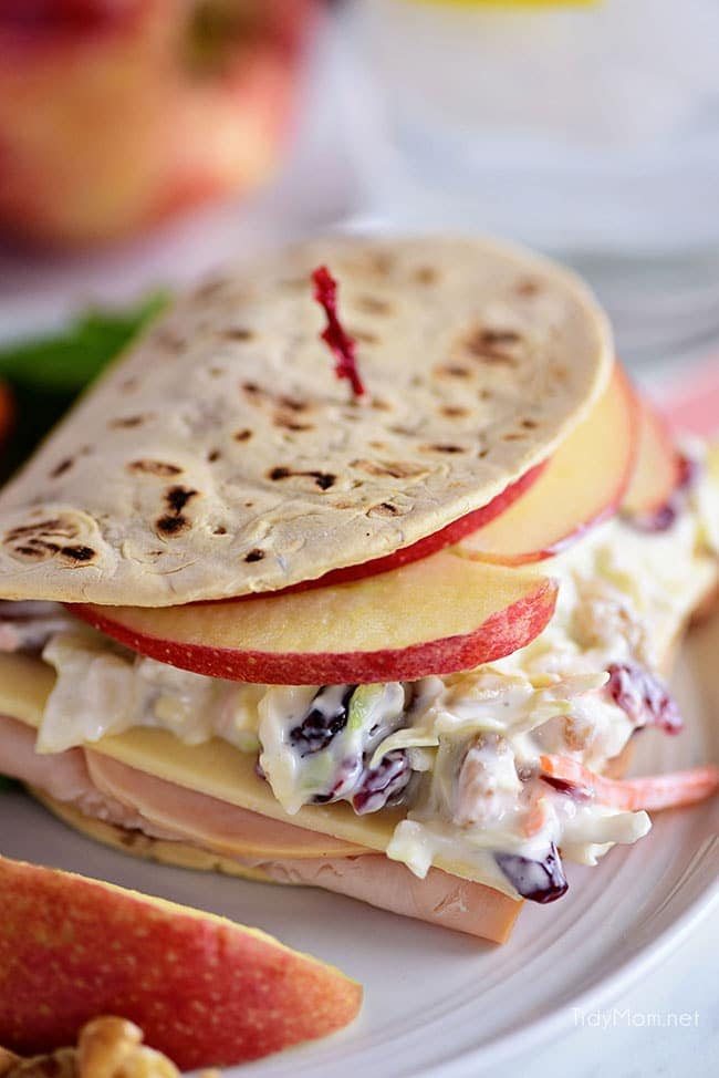 A favorite Panera restaurant sandwich gets a little healthier when you make it at home! Turkey, white cheddar, crisp apple slices, and a crunchy tangy slaw are slipped into a flatbread sandwich. This Turkey, Apple & Cheddar Sandwich is packed with flavor and makes a quick, easy and delicious meal! Print the full recipe at cetcu.com