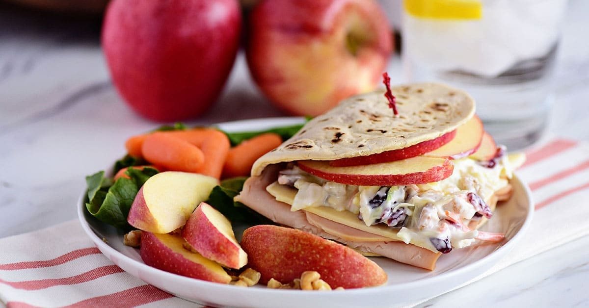 A favorite Panera restaurant sandwich gets a little healthier when you make it at home! Turkey, white cheddar, crisp apple slices, and a crunchy tangy slaw are slipped into a flatbread sandwich. This Turkey, Apple & Cheddar Sandwich is packed with flavor and makes a quick, easy and delicious meal! Print the full recipe at cetcu.com