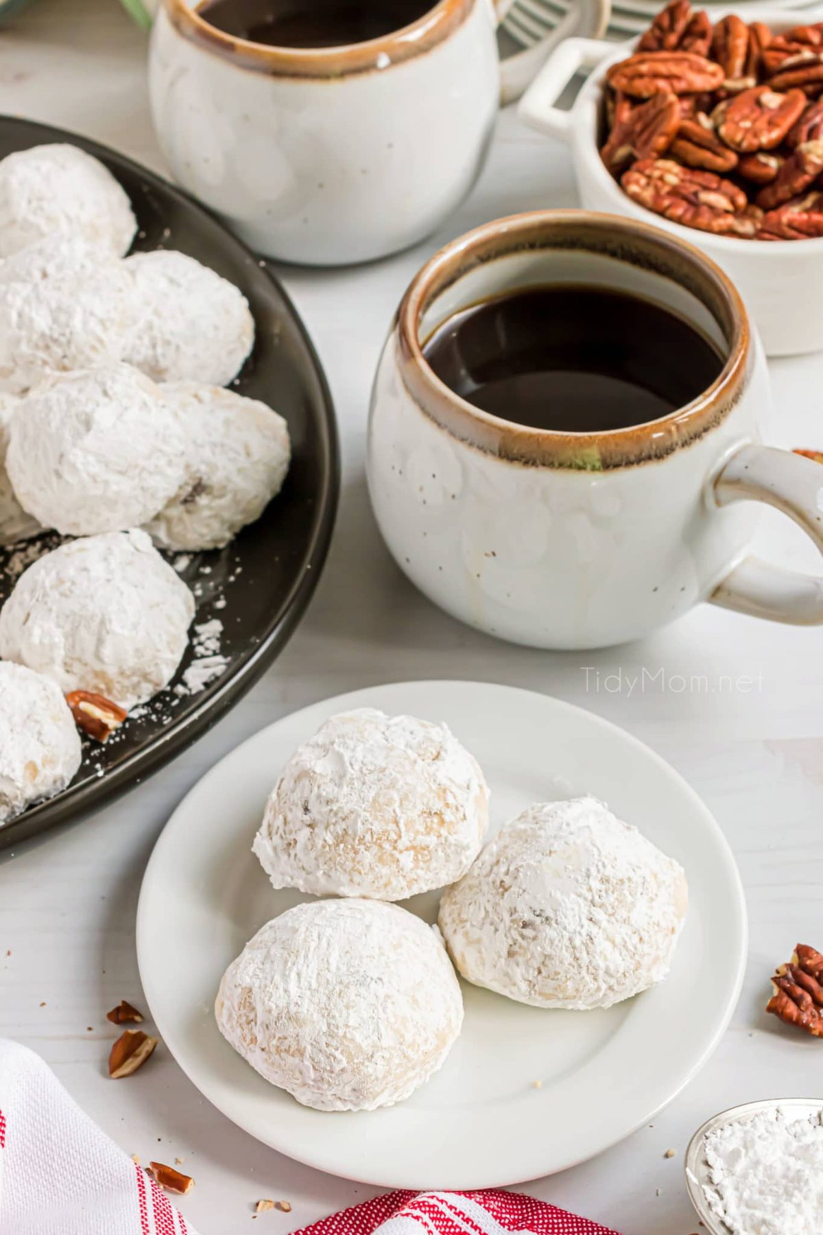 russian tea cakes on a plate with a hot mug of coffee