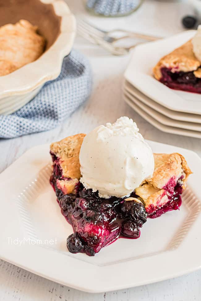 blueberry galette with a scoop of vanilla ice cream on a white plate