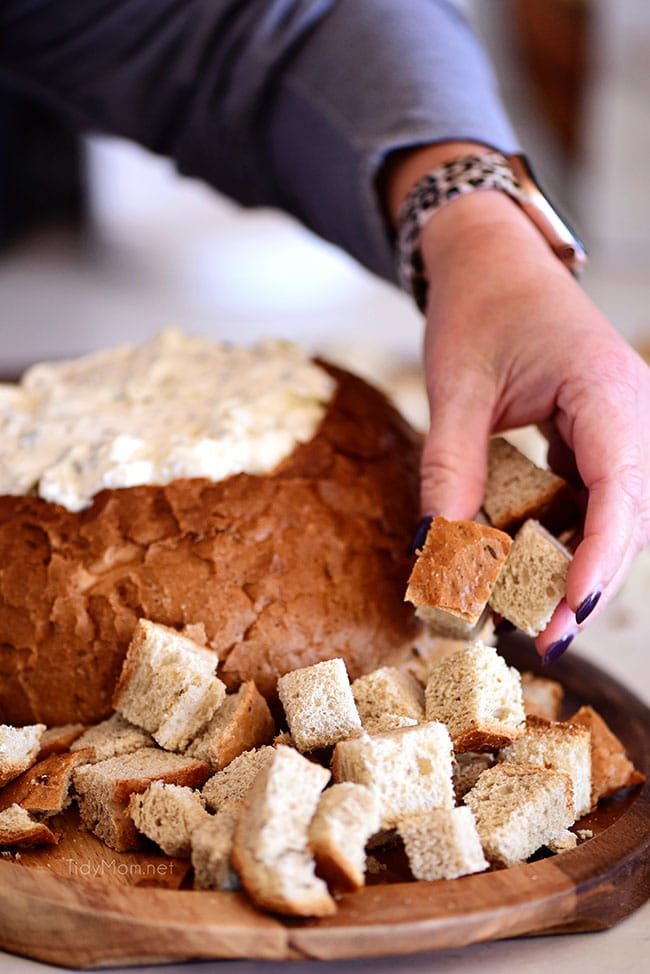 placing cubed bread around a Rye Bread Dip Bowl