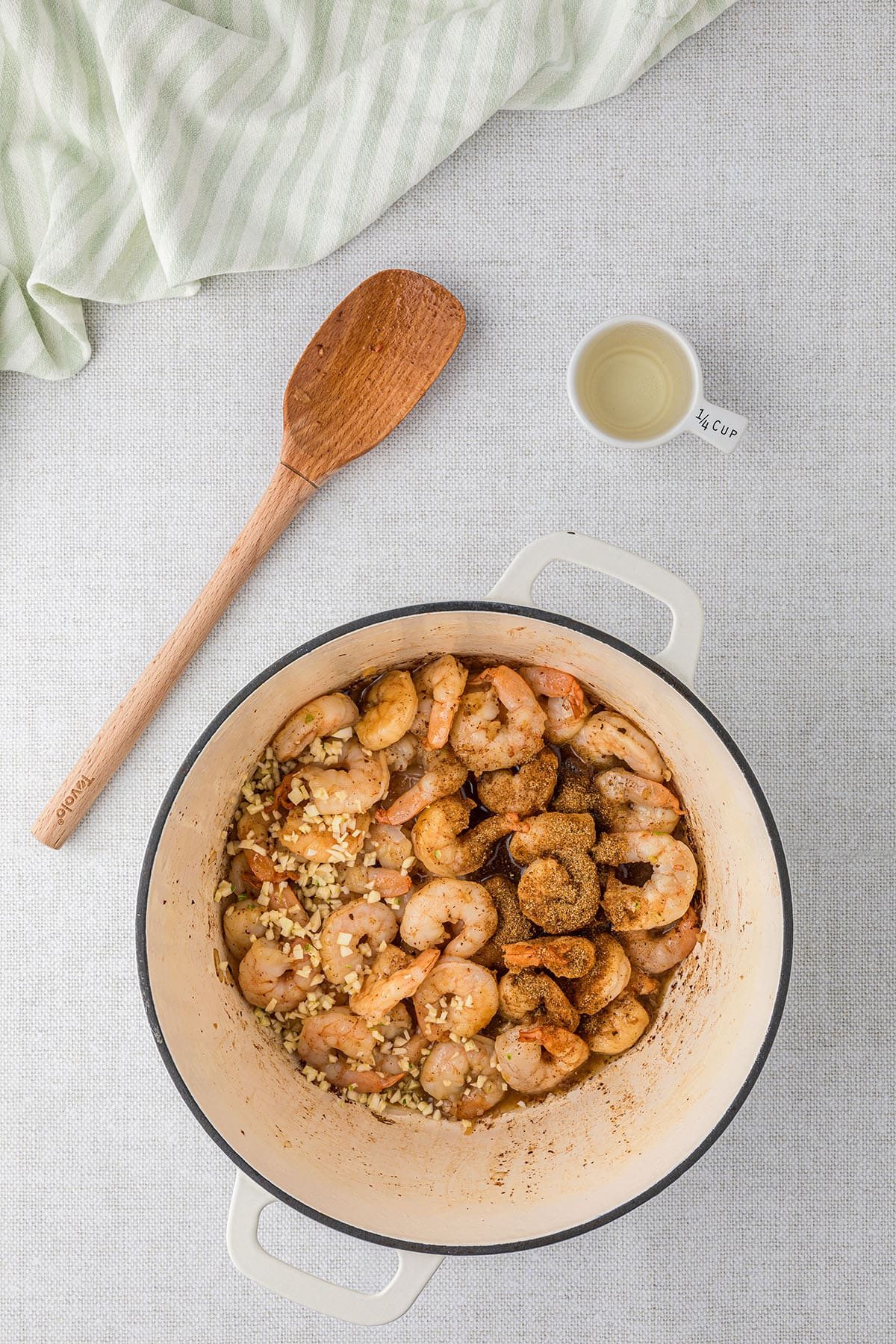 making shrimp corn chowder in a white dutch oven step 1