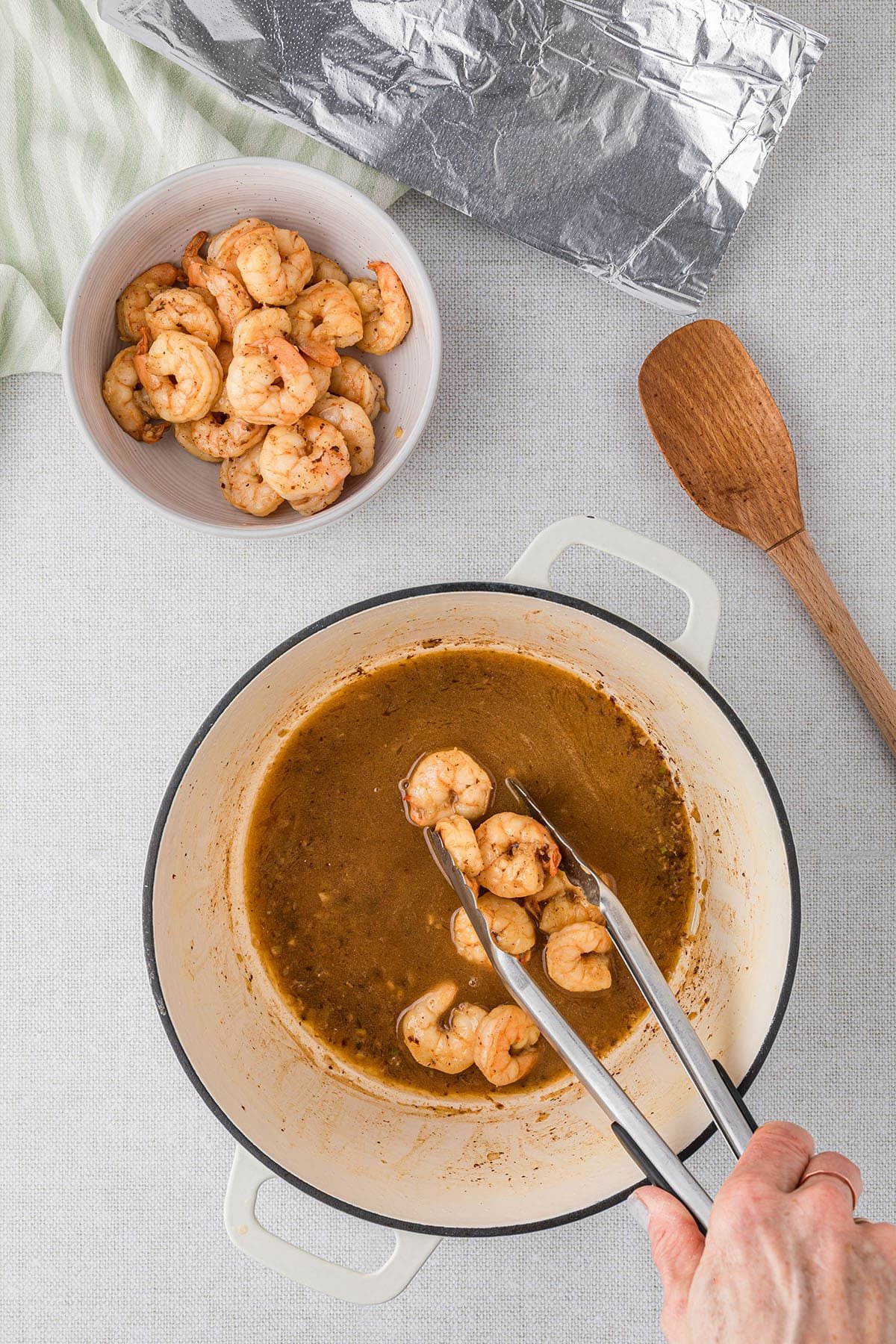 cooking shrimp for corn chowder in a white dutch oven step 2