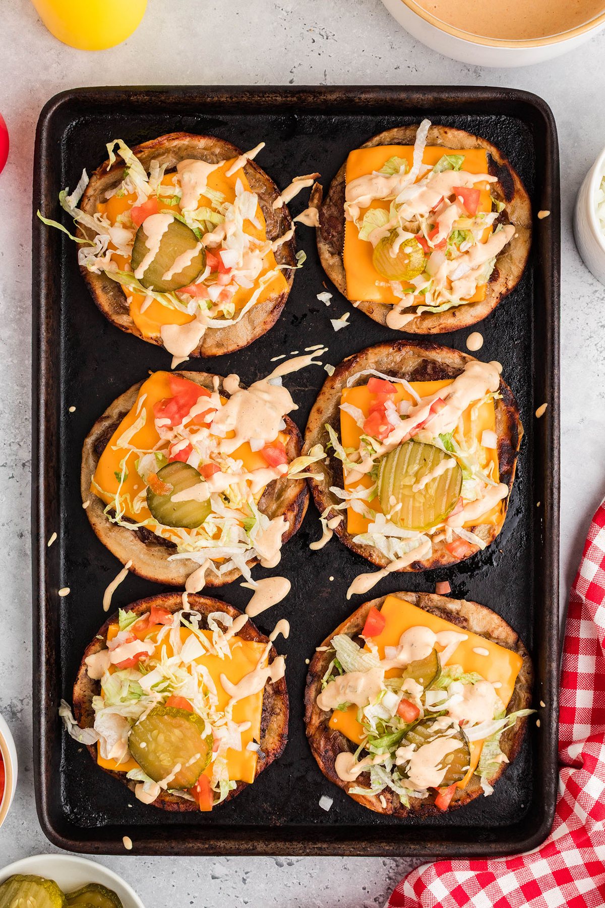 Smash burger tacos with melted cheese and fresh toppings on a serving tray