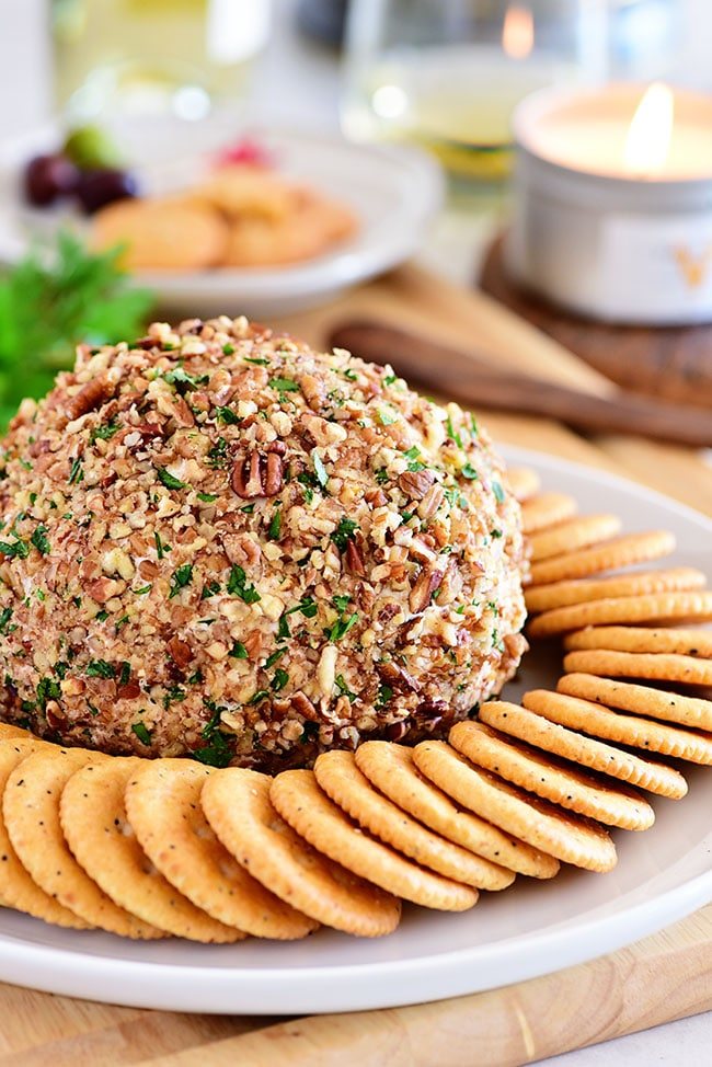 classic cheese ball on a plate with crackers