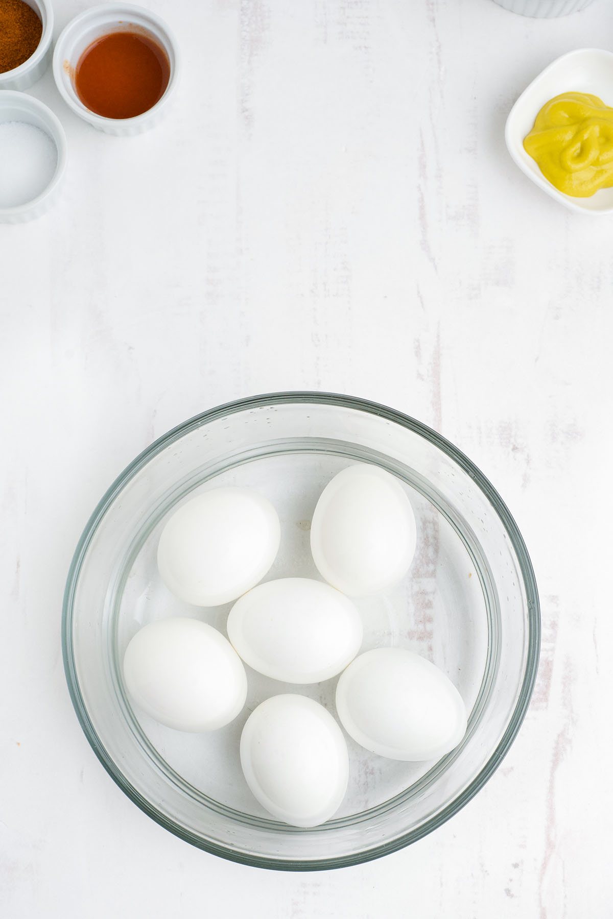 hard cooked eggs in a bowl of water