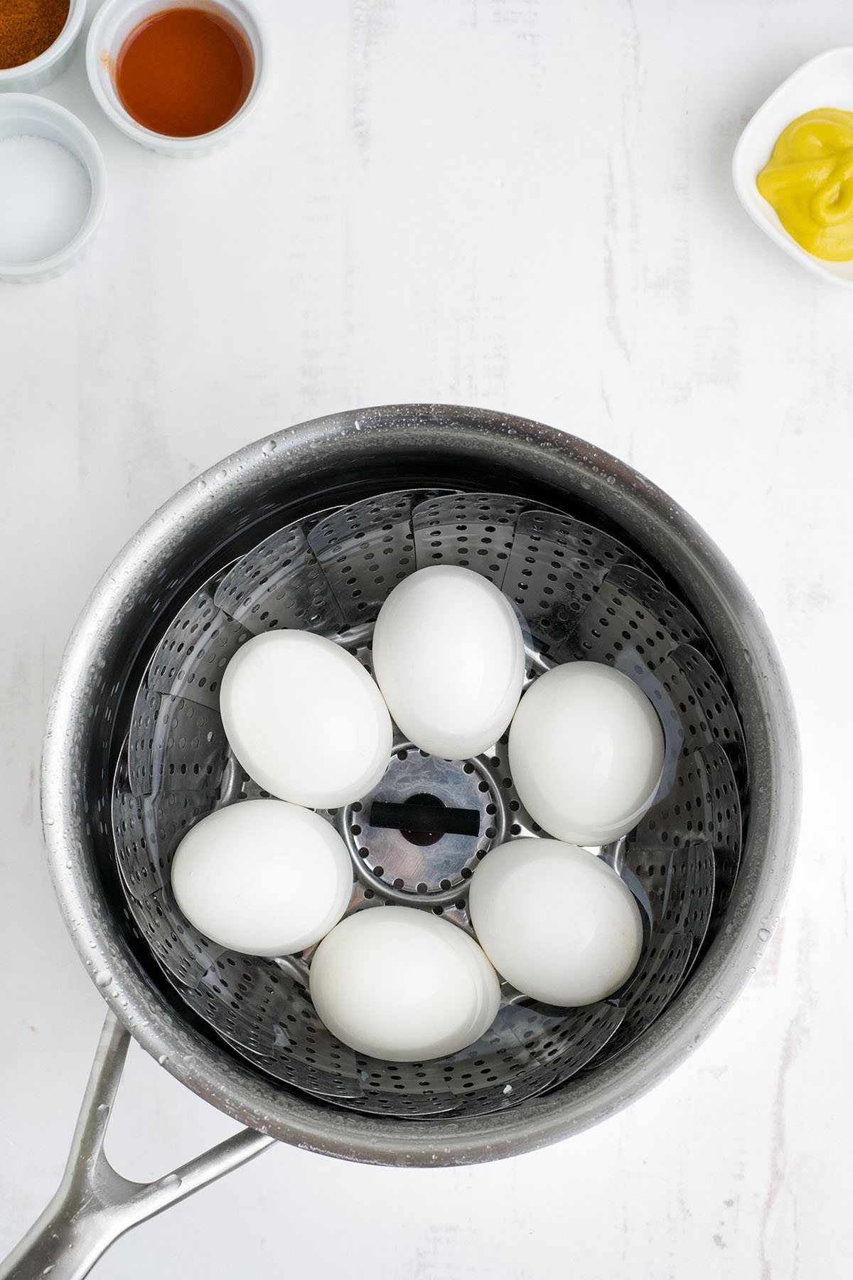 hard cooked eggs in a sauce pan