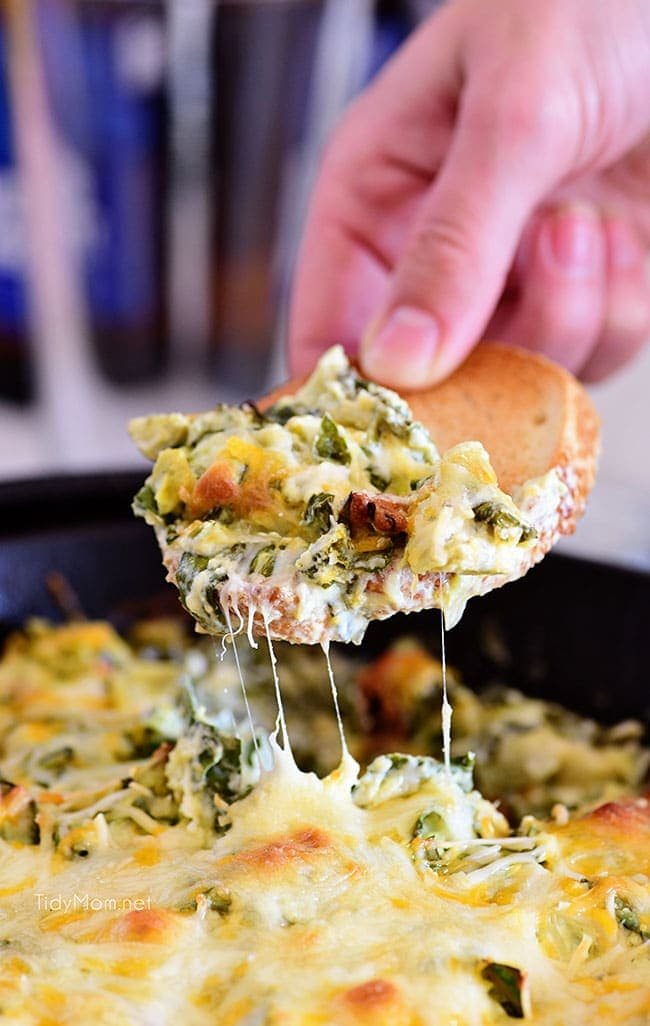 hot cheesy Spinach Artichoke Dip on toasted baguette