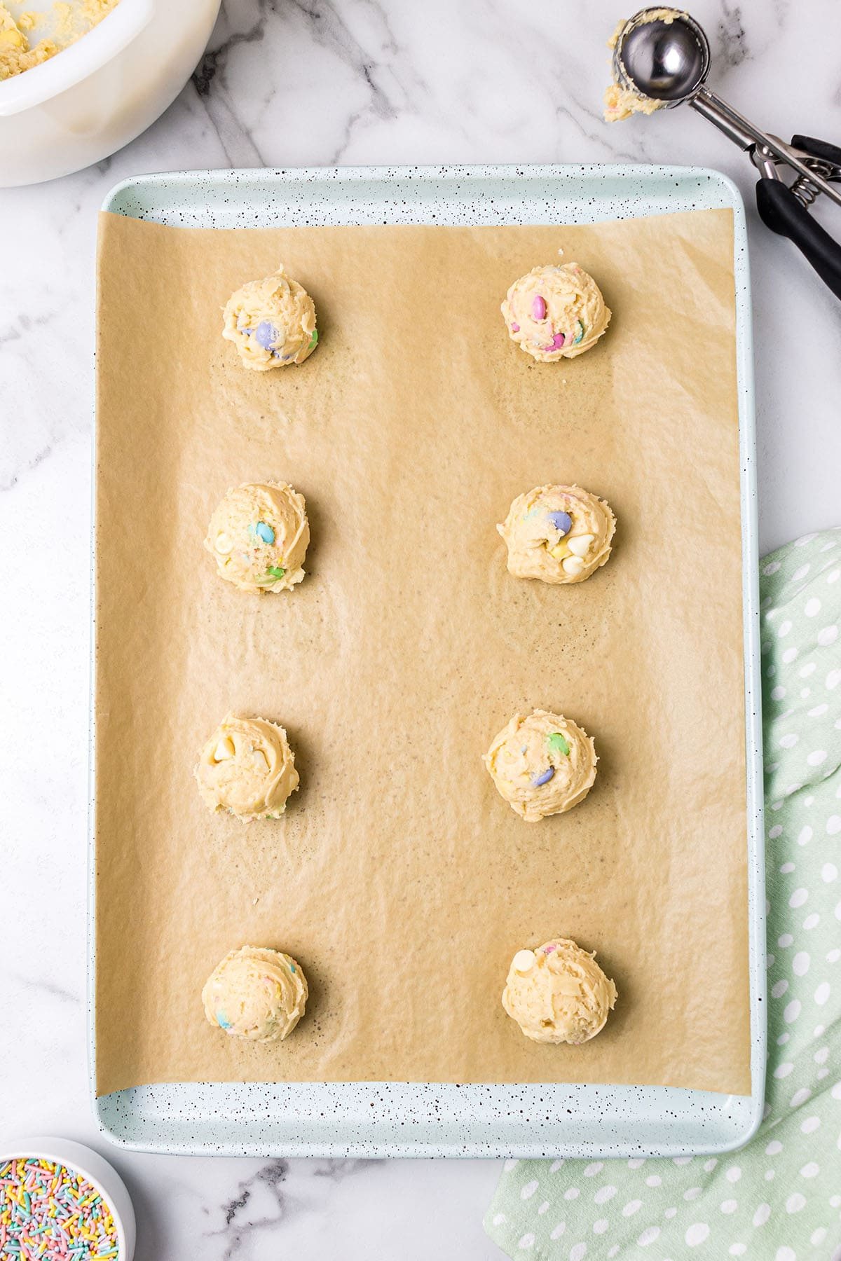 cookie dough balls on a baking sheet
