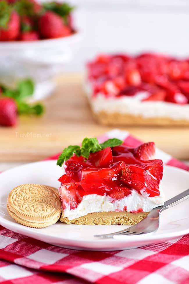 Strawberries and Cream Magic Bars made with fresh glazed strawberries and a sweet cream cheese layer with a Golden Oreo cookie crust! Chill for a tasty summer dessert!