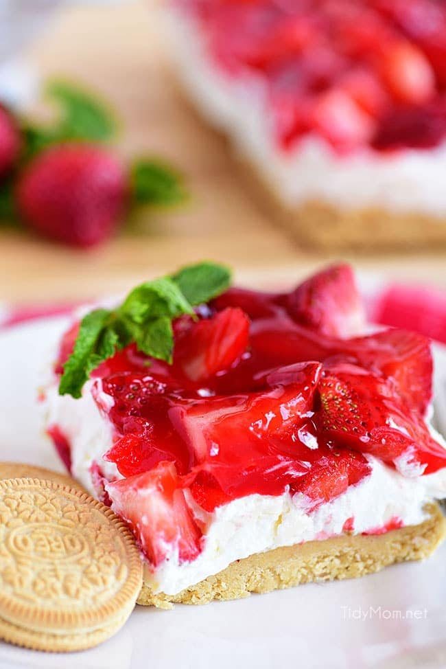 Strawberries and Cream Magic Bars made with fresh strawberries and a sweet cream cheese layer with a Golden Oreo cookie crust! Chill for a tasty summer dessert!