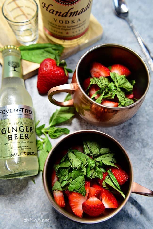 Strawberry Basil Moscow Mule is the perfect summer cocktail. Made like a traditional Moscow Mule with vodka, ginger beer and lime, with the addition of muddled fresh strawberries and basil. Print the recipe at cetcu.com Delicious!