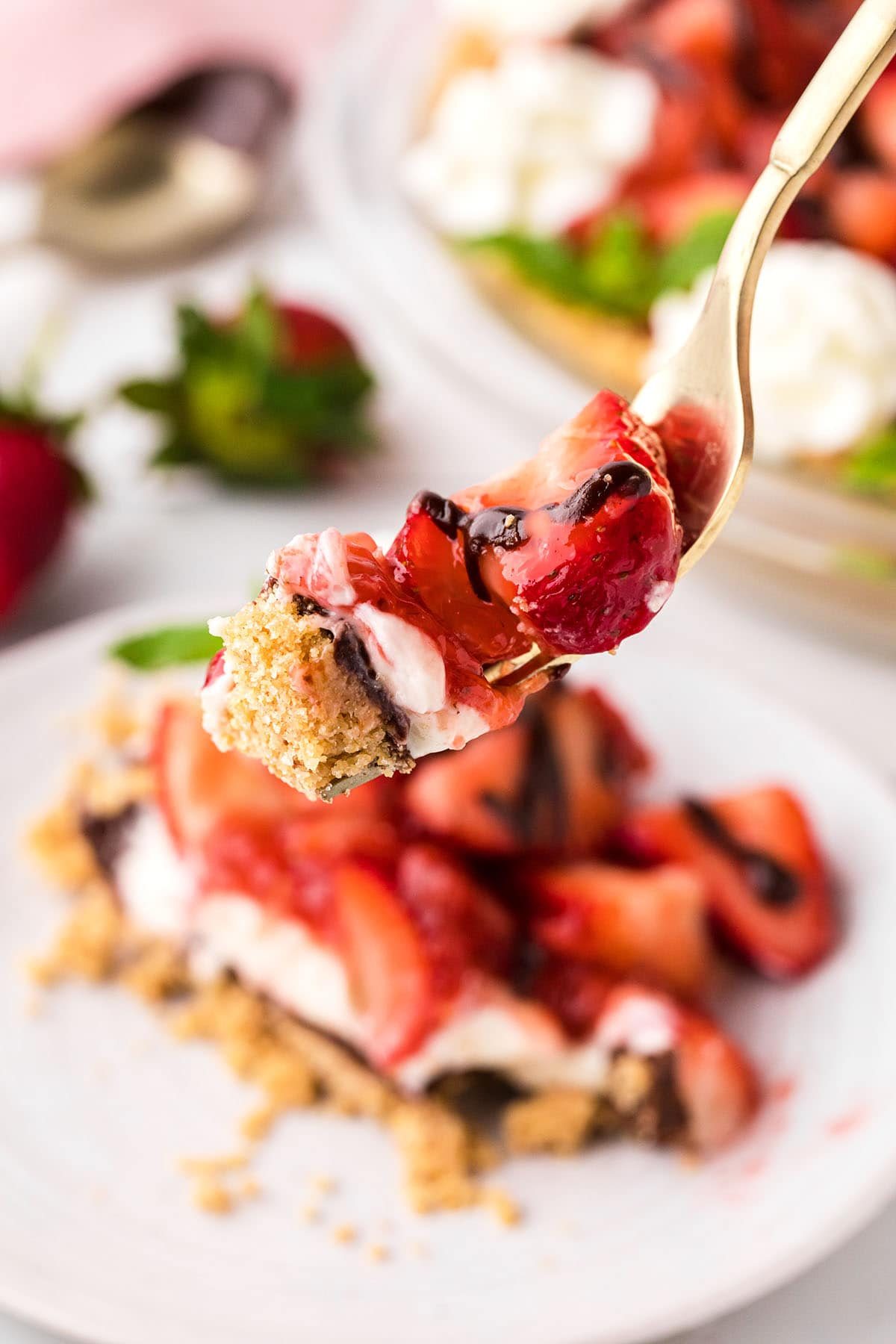 fresh strawberry pie slice with a bite on a fork