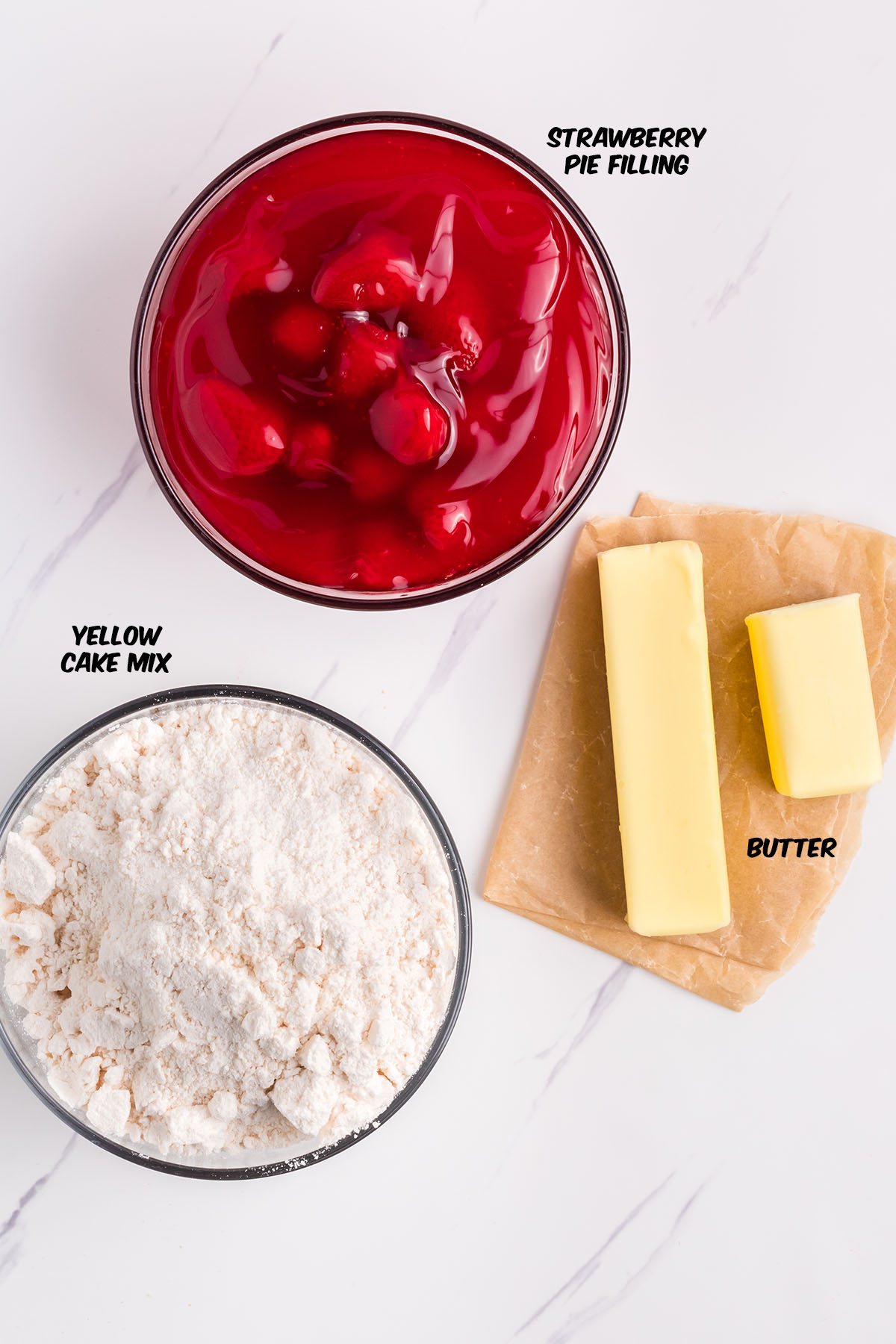 ingredients for strawberry dump cake on a counter