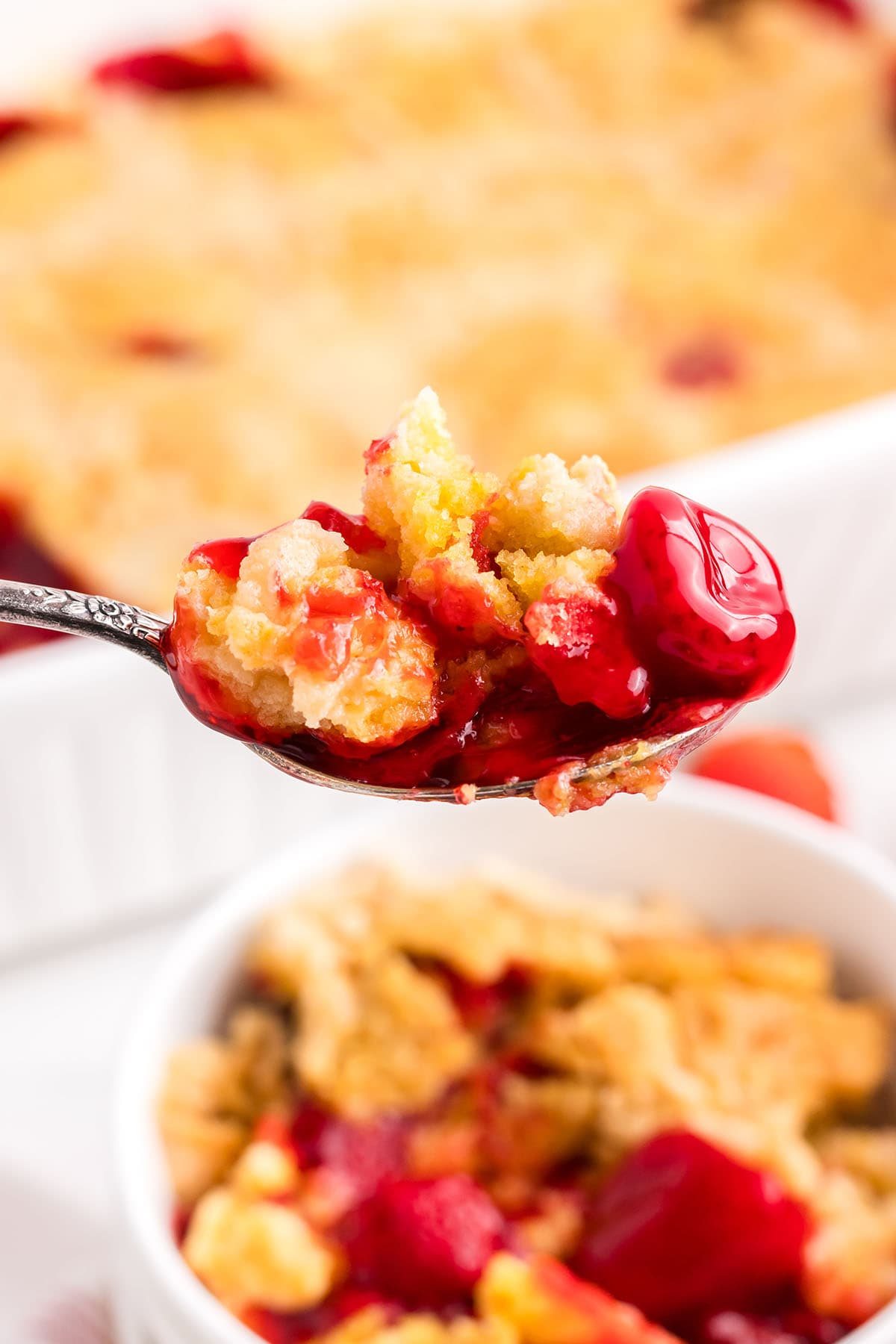 strawberry dump cake on a spoon