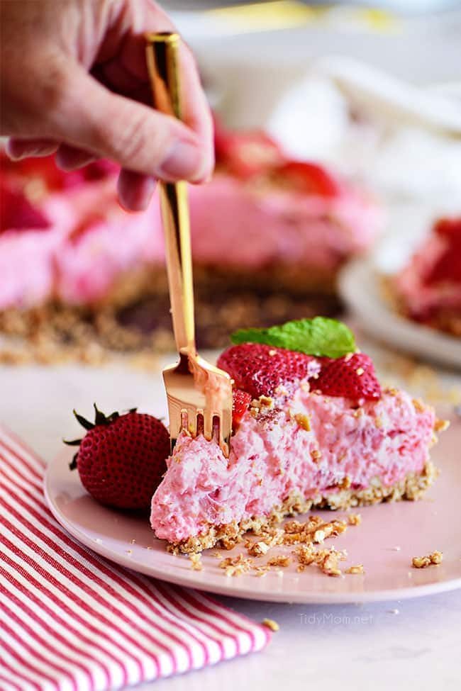 gold fork in a piece of a slice of strawberry pretzel pie