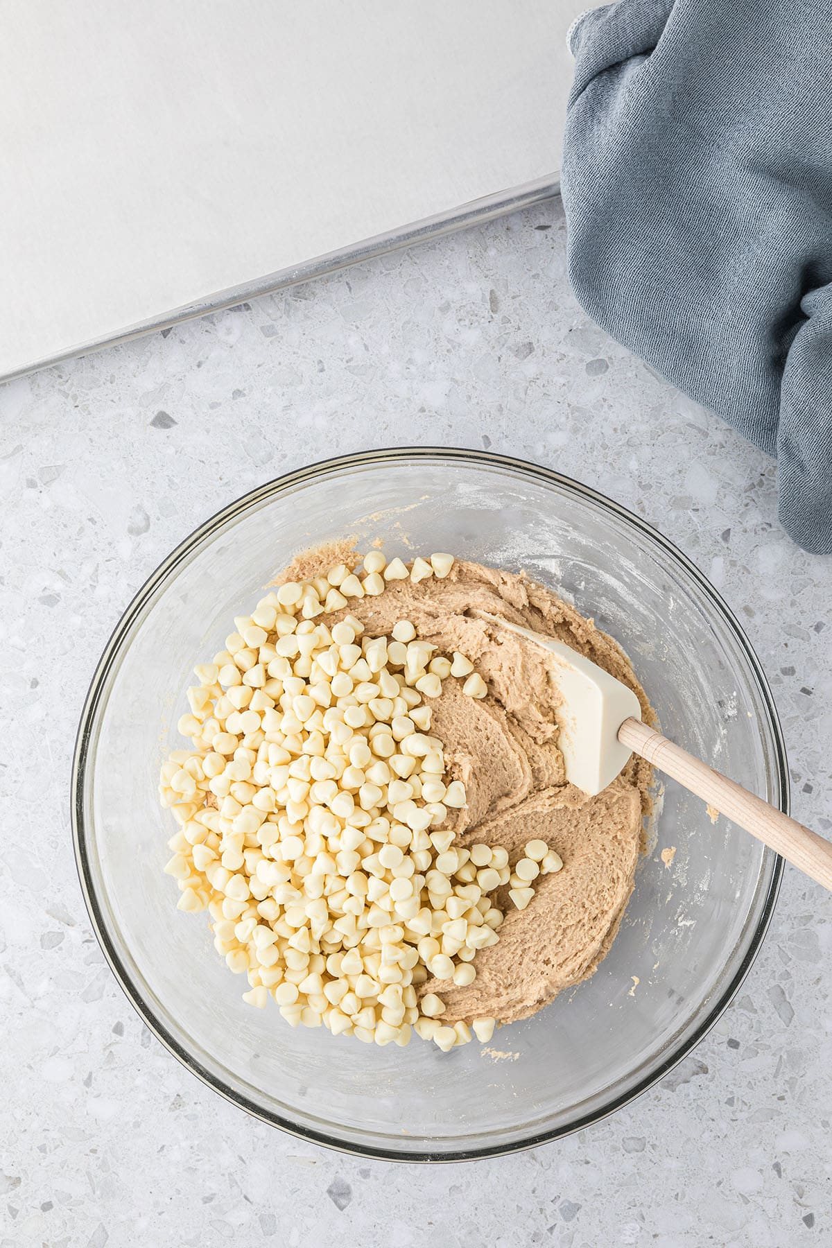 glass mixing bowl with cinnamon sugar cookie dough and white chocolate chips