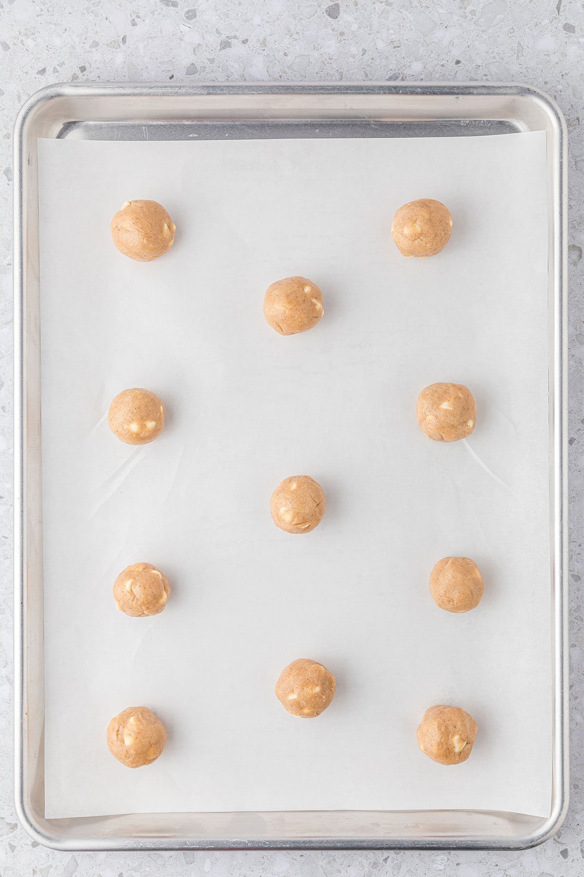 cookie dough balls on a baking sheet