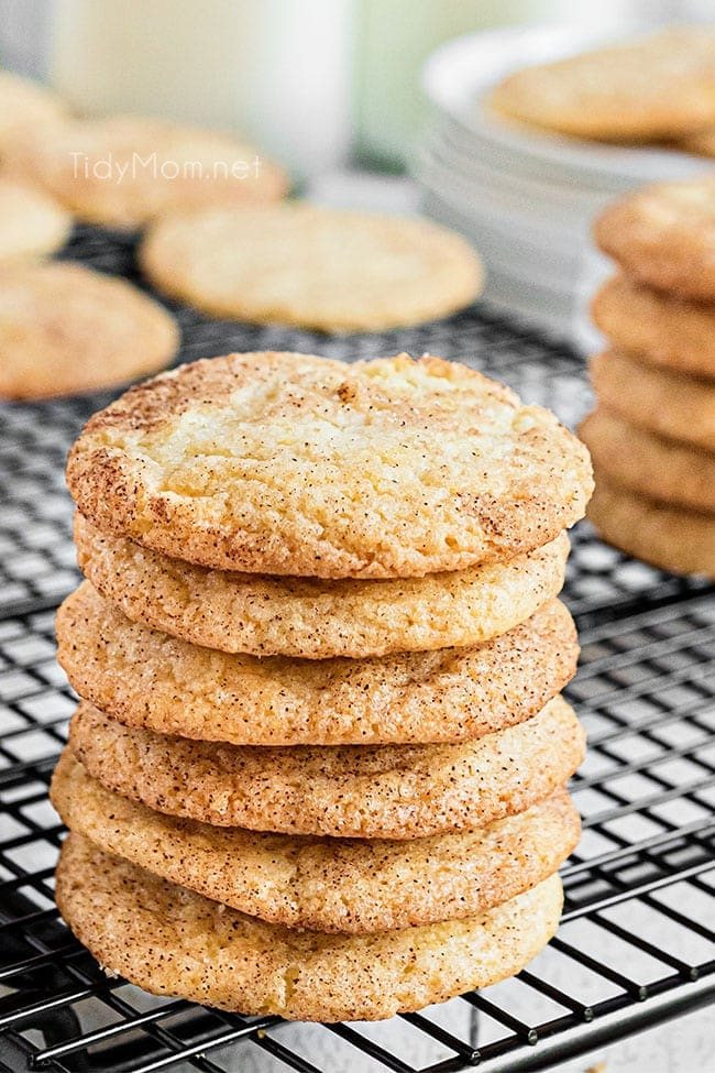 Six snickerdoodles stacked together sitting on a cooling rack