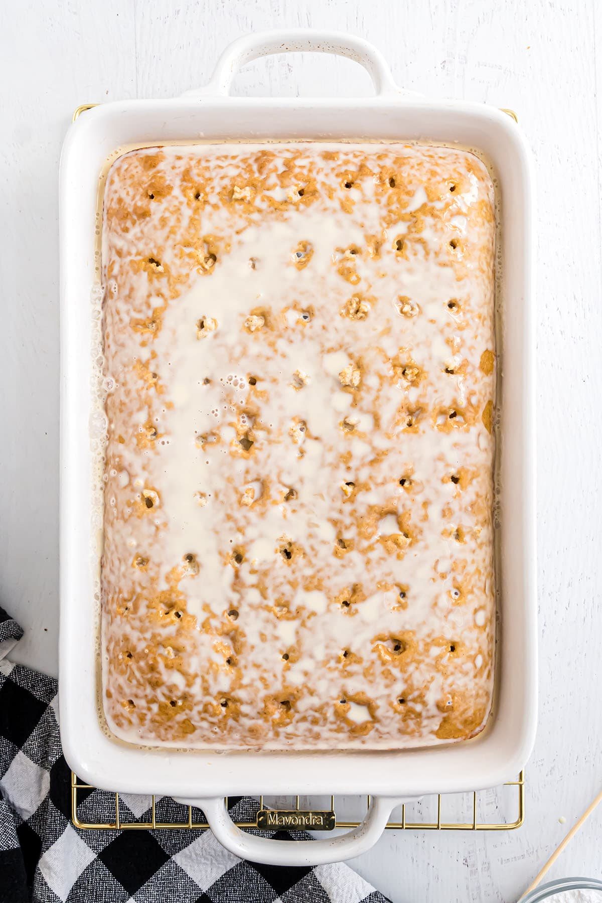 making an easy tres leches cake - Step 3, covering cake with sweetened milks