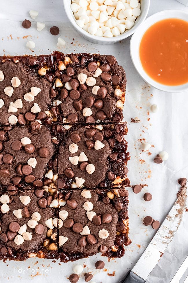 chocolate caramel bars cut and on a piece of parchment paper