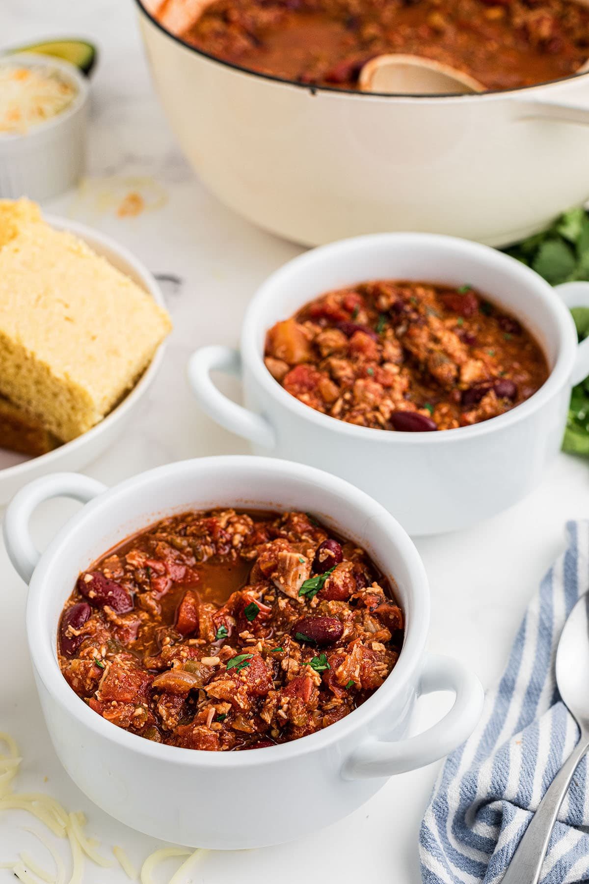 homemade chili in white soup bowls.