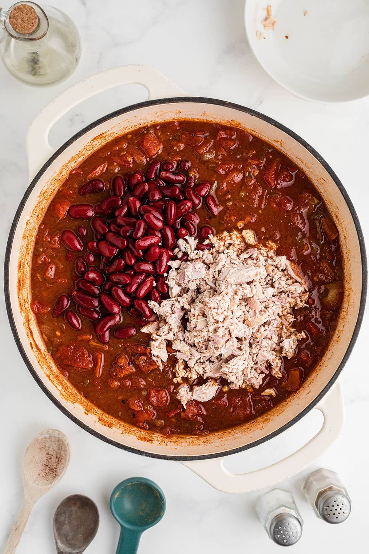 adding turkey and beans to chili pot