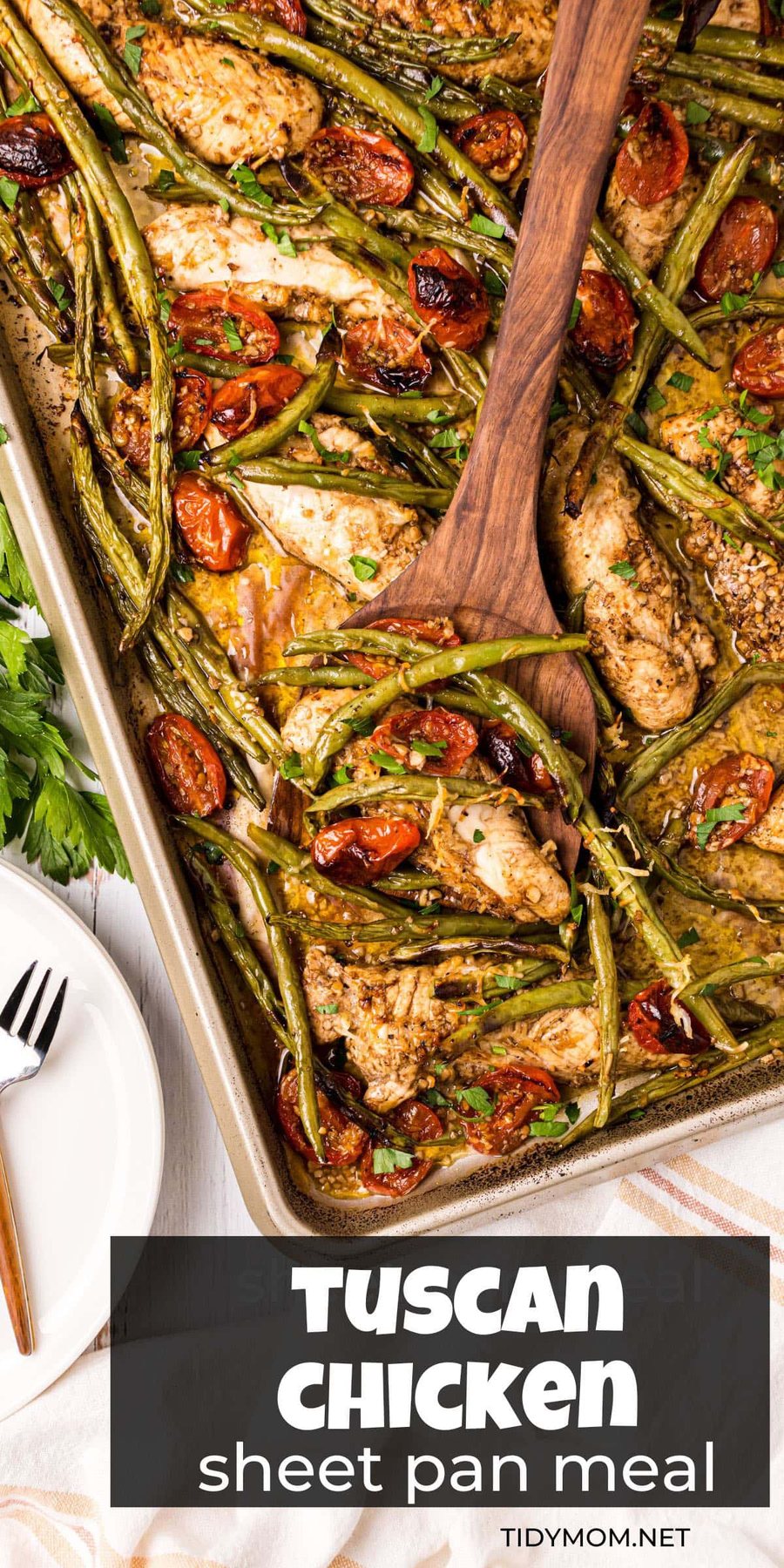 chicken tenders, green beans and tomatoes on a large sheet pan