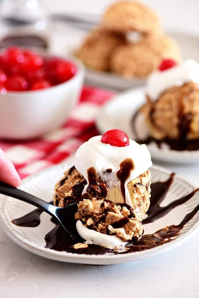 fried ice cream on a plate with chocolate syrup