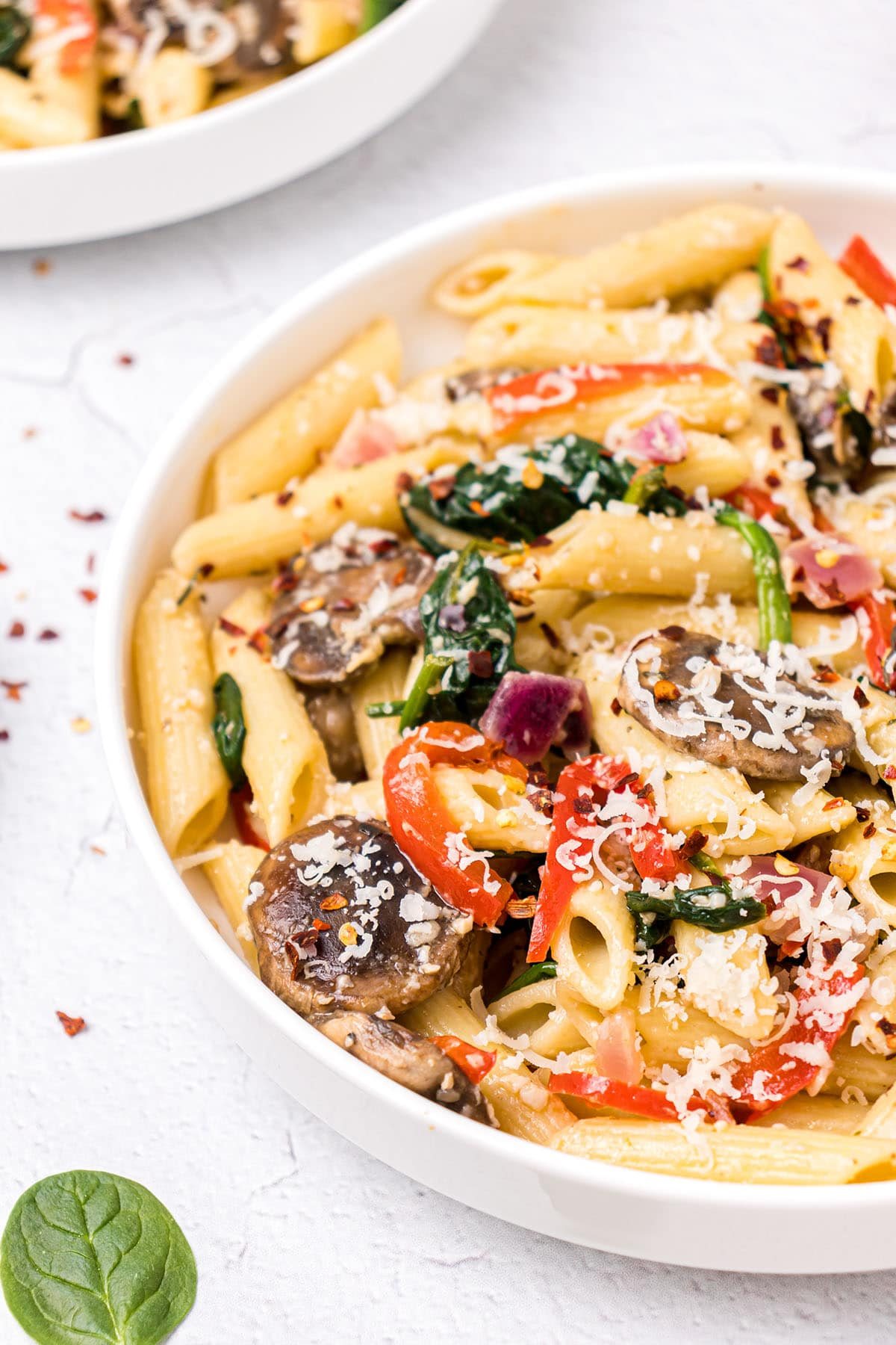 bowl of pasta with veggies on a talbe