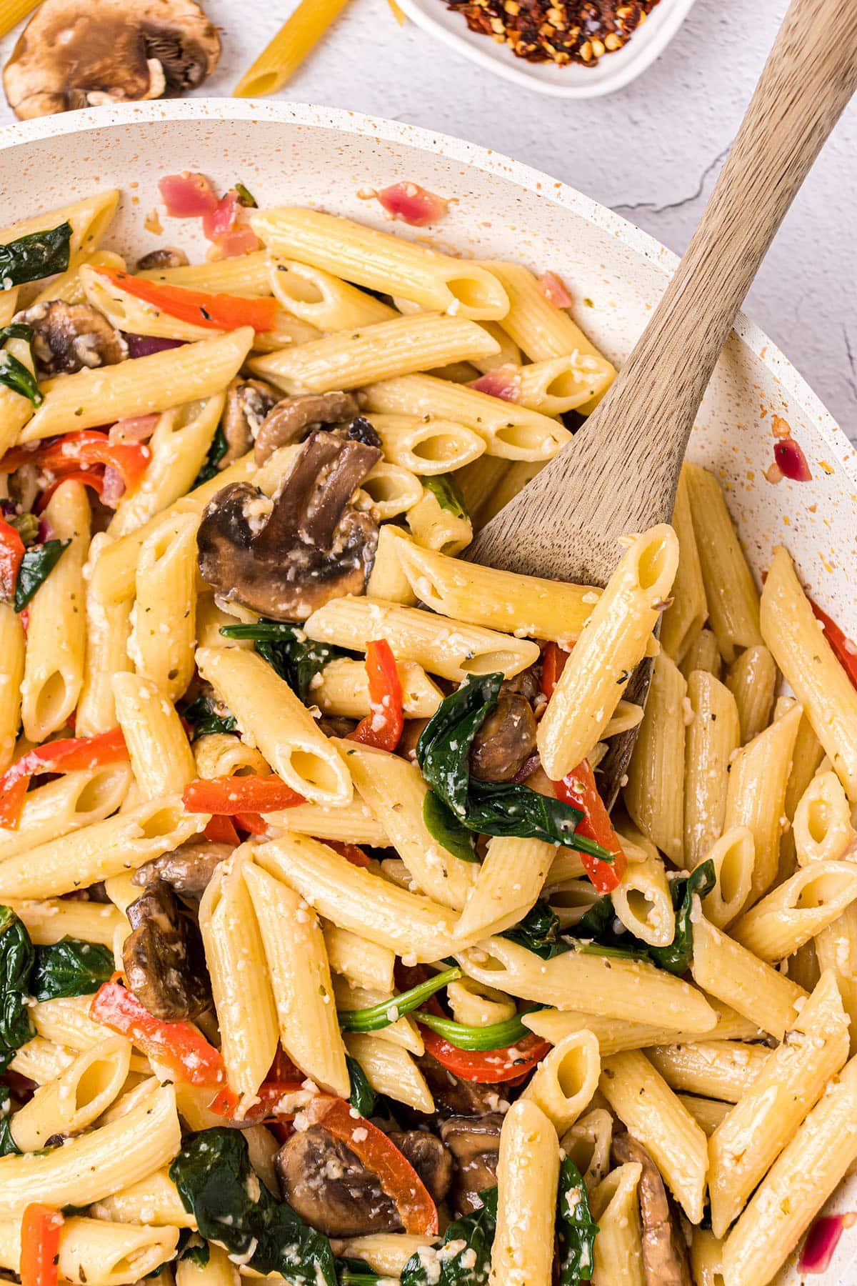 Veggie Pasta in a bowl with a wooden spoon