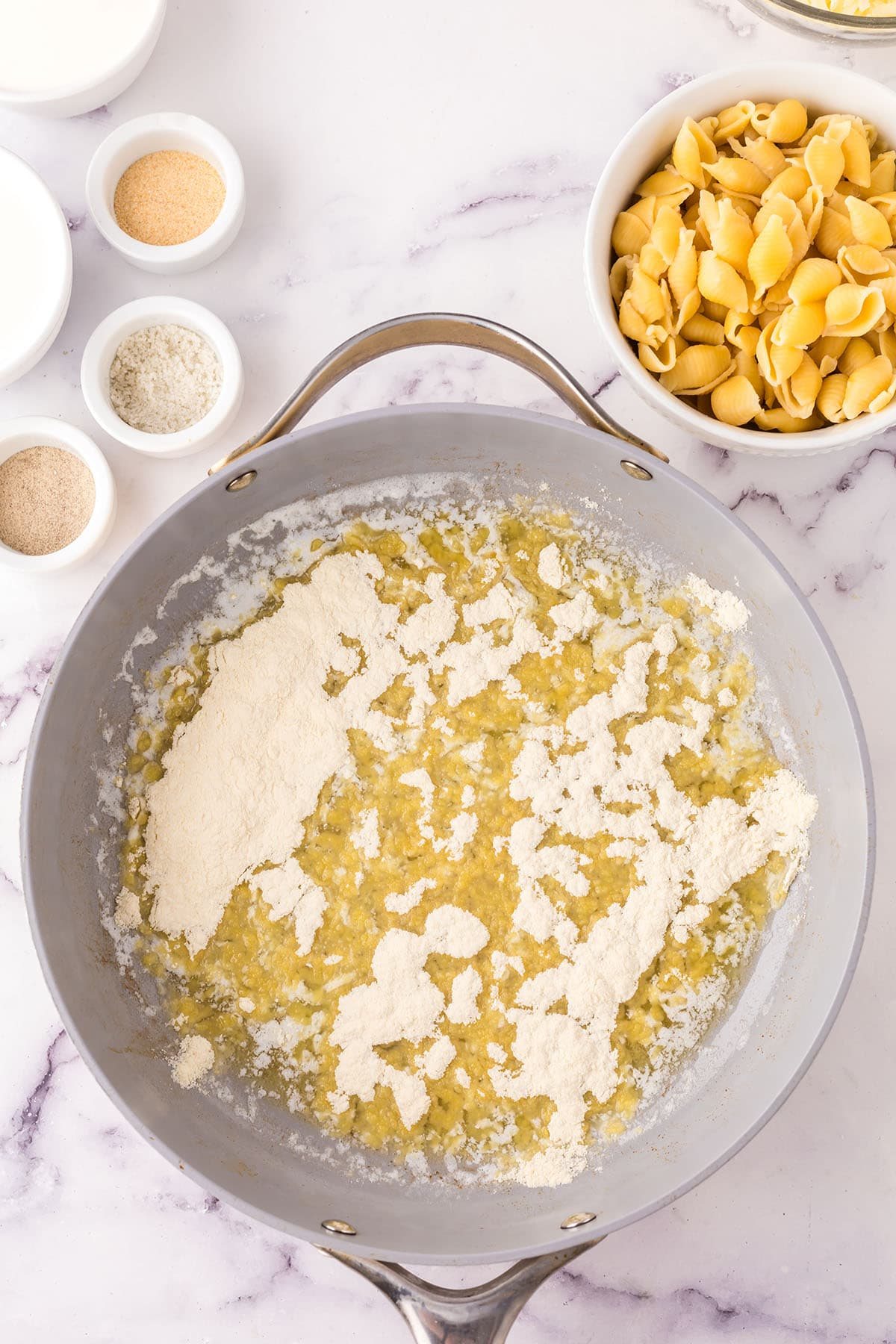 making mac and cheese sauce in a skillet