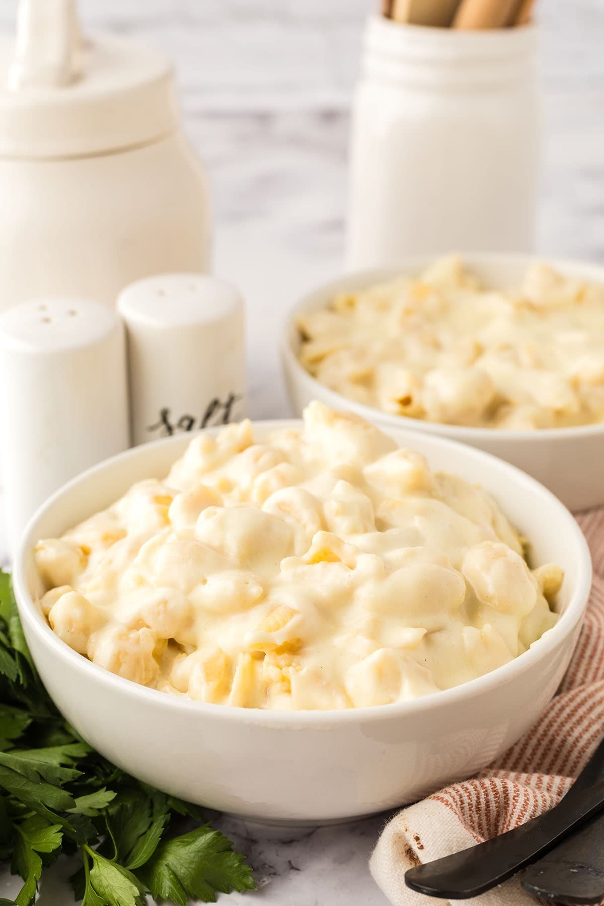 two white bowls of Homemade White Cheddar Mac And Cheese