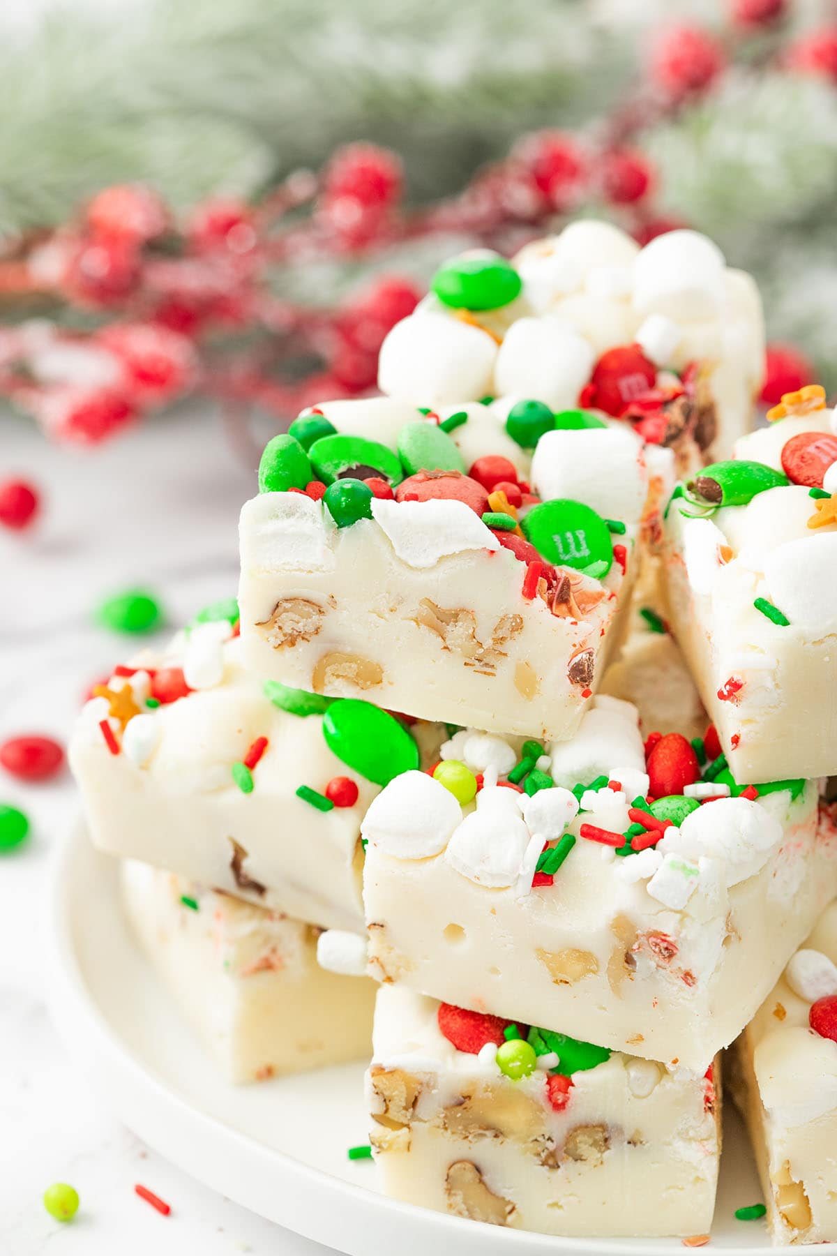 white rocky road fudge stacked on a white plate