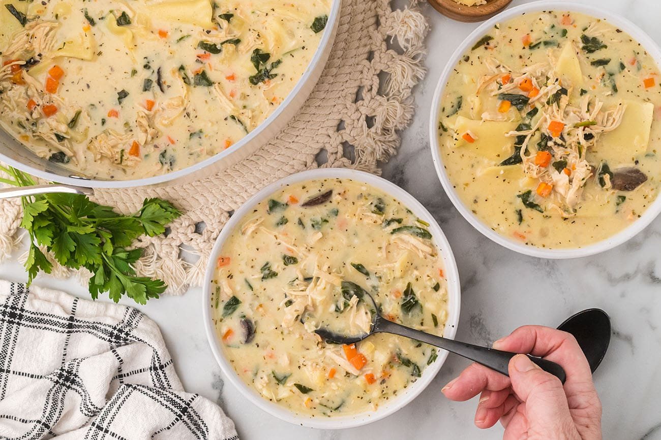 bowls of cozy white lasagna soup with spoons