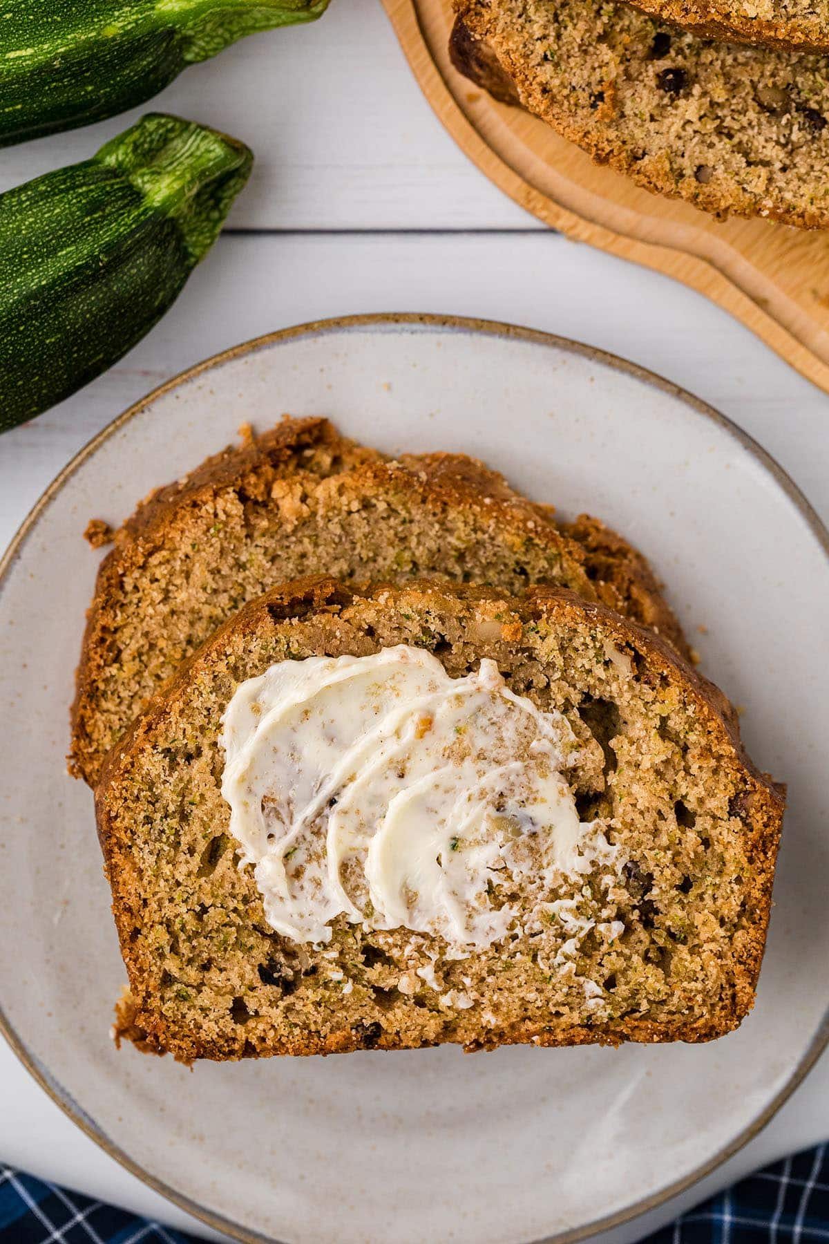 Homemade zucchini bread buttered and on a plate