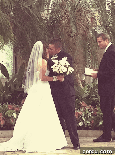 A heartfelt kiss between a newlywed couple, embodying love and commitment.