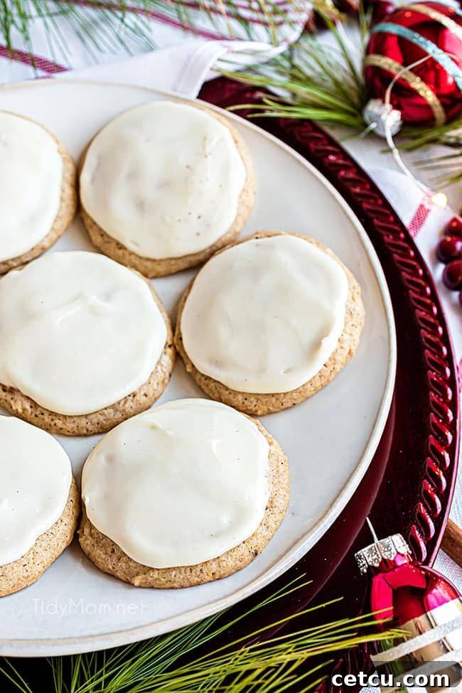 A plate of beautifully iced eggnog cookies, each one frosted with a smooth, creamy buttercream.