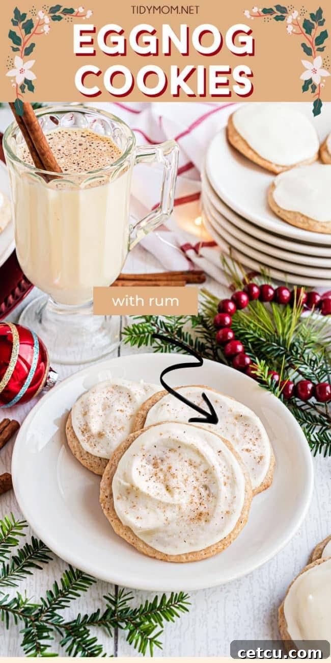A tall glass of eggnog next to a plate piled high with frosted eggnog cookies, evoking cozy holiday cheer.