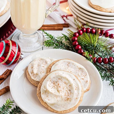 cookies on a plate with a mug of eggnog