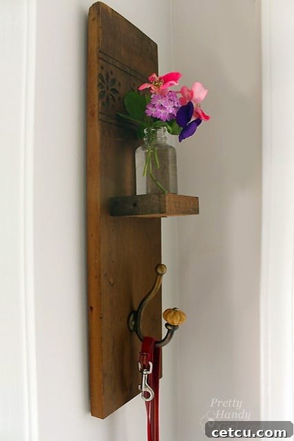 Reclaimed wood sconce with vase and hook, hanging on a wall