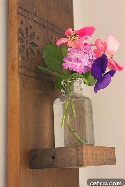 Close-up of fresh flowers in the vase of the reclaimed wood sconce