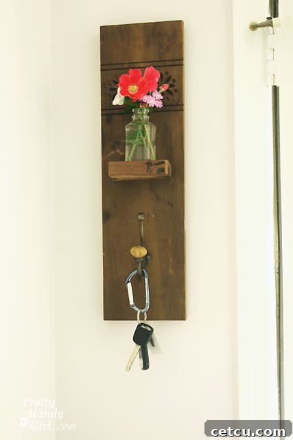 Keys hanging on the reclaimed wood wall hook with vase