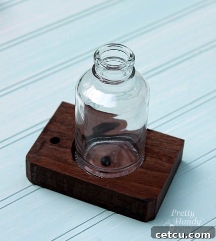 Testing the fit of a glass bottle in the drilled shelf hole