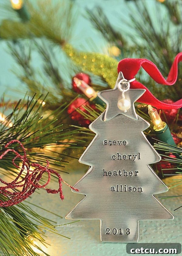 A close-up view of a personalized Christmas tree ornament, showcasing custom engraved names and intricate details, ideal for a unique family gift.