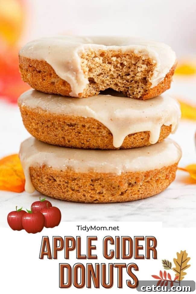 A towering stack of glazed apple cider donuts, ready for serving or sharing, against a cozy backdrop